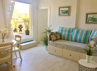 a living room with a couch and a table at Panoramic Apartments Sitges in Sitges