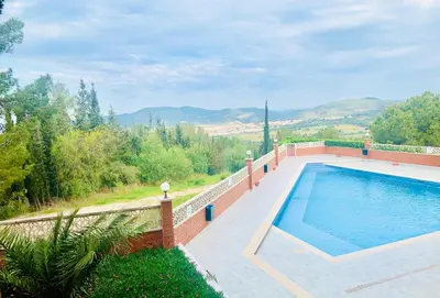 a swimming pool with a view of the mountains at Panoramic Apartments Sitges in Sitges