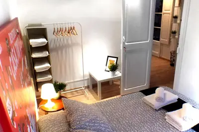 a small room with a bed and a closet at Casa Tortilla Gracia in Barcelona
