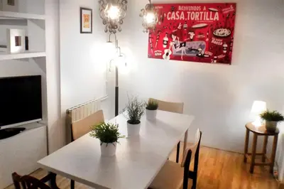a dining room with a white table and chairs at Casa Tortilla Gracia in Barcelona
