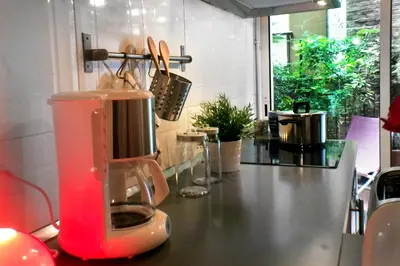 a red blender sitting on a counter in a kitchen at Casa Tortilla Gracia in Barcelona
