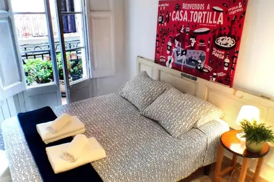 a small living room with a couch and a table at Casa Tortilla Gracia in Barcelona