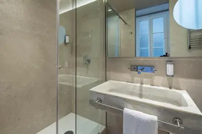 a bathroom with a sink and a glass shower at Habitat Apartments Garden View in Barcelona