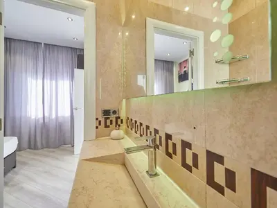 a bathroom with a sink and a mirror at Unique Cozy Scenic Penthouse in Barcelona