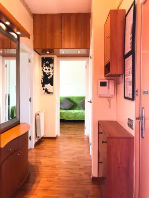 a kitchen with wooden floors and a hallway with a door at Unique Cozy Scenic Penthouse in Barcelona