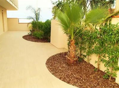 a palm tree in the middle of a hallway at Apartamentos Voramar in Castelldefels