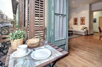 a table with plates on it in a living room at Habitat Apartments Bruc Terrace in Barcelona