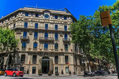 a building with a clock on the front of it at Habitat Apartments Bruc Terrace in Barcelona
