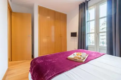 a bedroom with a bed with a purple blanket at Sibs Bcn- Balmes- Romantic CityCentre Beautiful in Barcelona