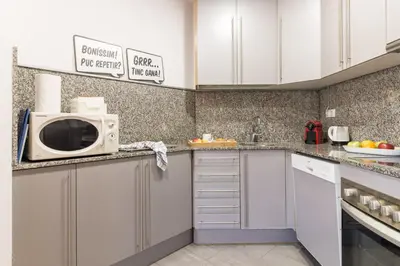a kitchen with white cabinets and a microwave at Sibs Bcn- Balmes- Romantic CityCentre Beautiful in Barcelona