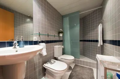 a bathroom with a sink and a toilet and a shower at Sibs Bcn- Balmes- Romantic CityCentre Beautiful in Barcelona