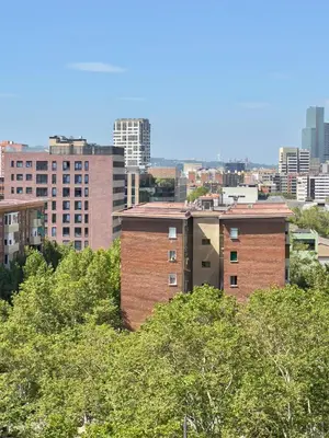 a city skyline with tall buildings and trees at Nova Mar Bella Apartment in Barcelona