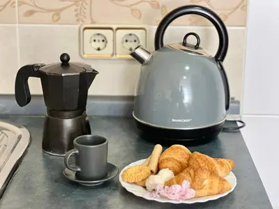 a plate of croissants and a tea kettle on a counter at Nova Mar Bella Apartment in Barcelona