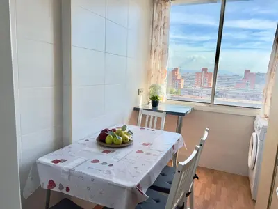 a table with a bowl of fruit on it in a room with a window at Nova Mar Bella Apartment in Barcelona