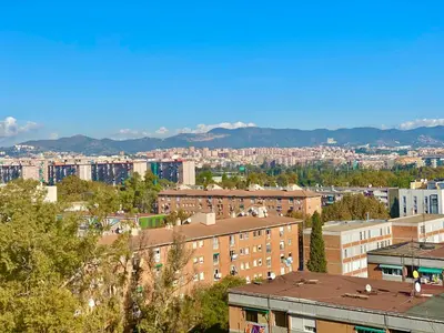 a view of a city with buildings and mountains at Nova Mar Bella Apartment in Barcelona