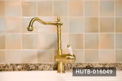 a bathroom sink with a gold faucet at Elegant Sitges Apartment in Sitges