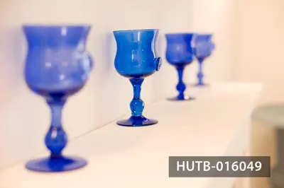 a row of blue wine glasses sitting on a shelf at Elegant Sitges Apartment in Sitges