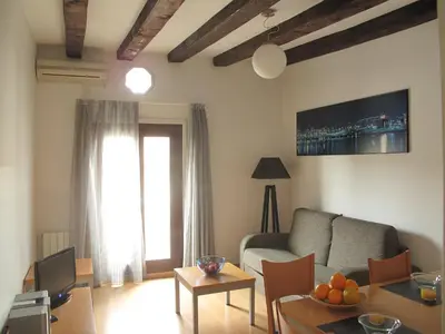 a living room with a couch and a table at My Address in Barcelona Downtown in Barcelona