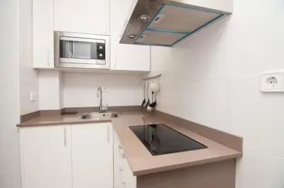 a small kitchen with a sink and a microwave at Charming Gracia 2 bedrooms in Barcelona