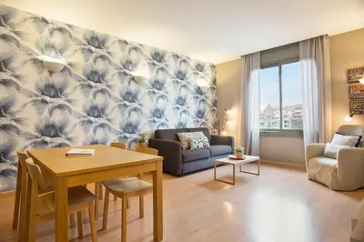 a living room with a table and a couch at Bonavista Apartments - Pedrera in Barcelona