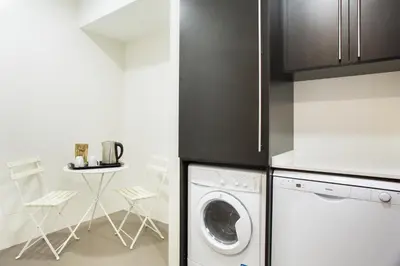 a kitchen with a washer and dryer in it at Bonavista Apartments - Pedrera in Barcelona