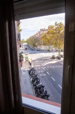 a view from a window of a street with parked motorcycles at DragonTree Barcelona - apartamentos turisticos 5 min from the BEACH in Barcelona