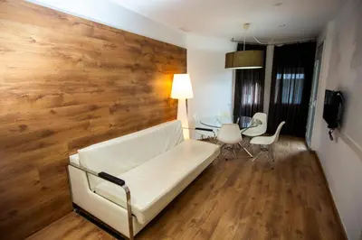 a living room with a white couch and a table at DragonTree Barcelona - apartamentos turisticos 5 min from the BEACH in Barcelona