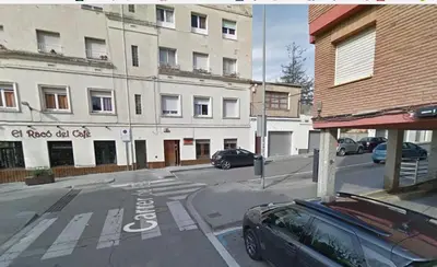 a street with a car parked in front of a building at Apartamento Manent in Premiá de Mar