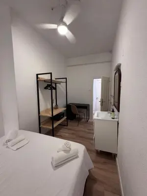 a room with a bed and a sink and a mirror at Calma House Barcelona in Barcelona