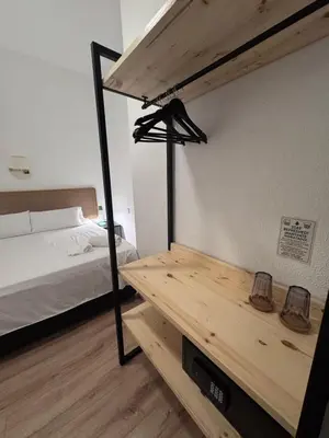 a bedroom with a loft bed and a wooden table at Calma House Barcelona in Barcelona
