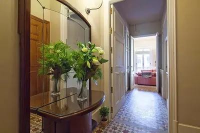 a hallway with a table with vases of flowers on it at Apartment Barcelona Rentals - Rambla de Catalunya Center in Barcelona