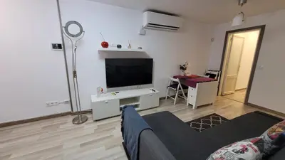 a living room with a flat screen tv and a couch at APARTAMENTS B O D CoLLBLANC in Hospitalet de Llobregat
