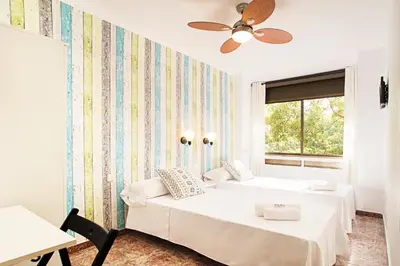 a bedroom with two beds and a window at Fira Guest House in Barcelona