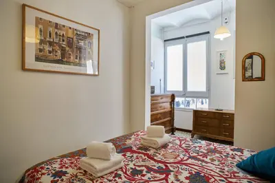 a bedroom with a bed with two chairs on it at My Home in Barcelona in Barcelona