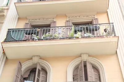 an apartment building with a balcony with plants on it at My Home in Barcelona in Barcelona