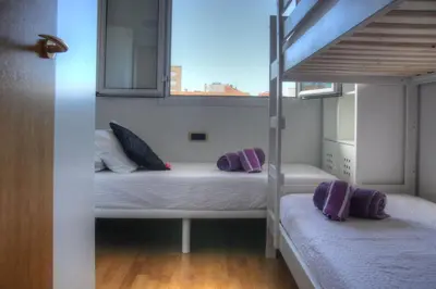 a bedroom with two bunk beds and a window at Barcelona Olympic Apartment in Barcelona