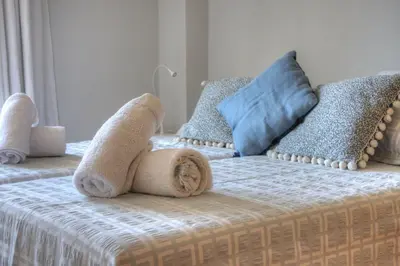 a bed with a stuffed animal on top of it at Barcelona Olympic Apartment in Barcelona