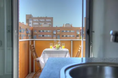 a table on a balcony with a view of a city at Barcelona Olympic Apartment in Barcelona