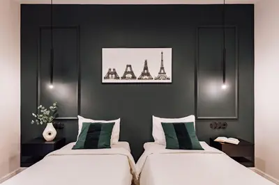 two beds in a room with black walls at Lunalux Apartment in Barcelona