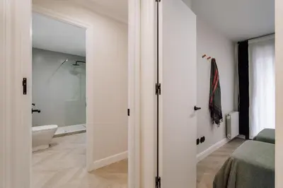a bathroom with a tub and a toilet in a room at Lunalux Apartment in Barcelona