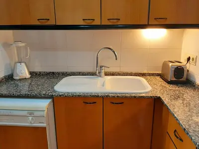 a kitchen counter with a sink and a blender at Barceló Cornellà in Cornellà de Llobregat