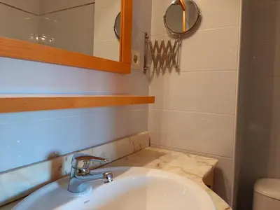 a bathroom with a sink and a mirror at Barceló Cornellà in Cornellà de Llobregat