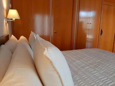 a bedroom with a bed with white pillows at Barceló Cornellà in Cornellà de Llobregat