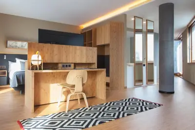 a kitchen with a desk and a chair in a room at Eurostars Barcelona Central in Barcelona