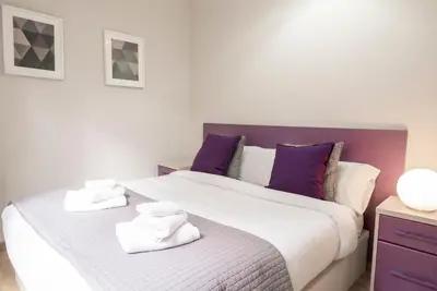 a bedroom with a large bed with towels on it at The Family Host - Lost Garden Ciutadella Park in Barcelona