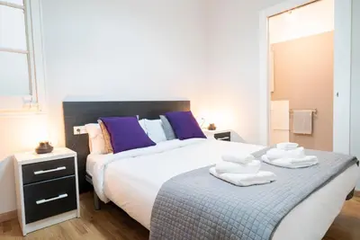 a bedroom with a bed with towels on it at The Family Host - Lost Garden Ciutadella Park in Barcelona