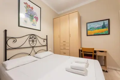 a bedroom with a white bed and a desk at ApartEasy - Family 4-Bedroom Apartment in Barcelona