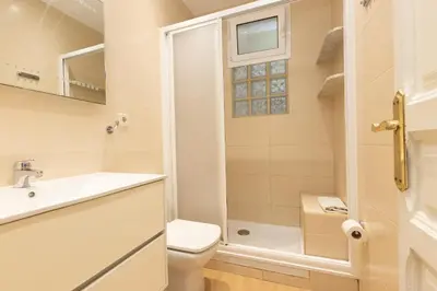 a bathroom with a toilet sink and a shower at ApartEasy - Family 4-Bedroom Apartment in Barcelona