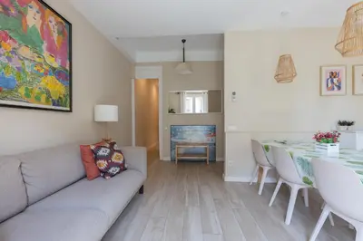 a living room with a couch and a table at ApartEasy - Family 4-Bedroom Apartment in Barcelona