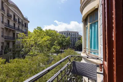 a balcony of a building with a bench on it at ApartEasy - Family 4-Bedroom Apartment in Barcelona